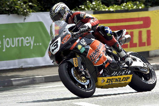 This image of 13-times TT winner during in action during the Centenary, by Geoff McCann, forms part of the exhibition